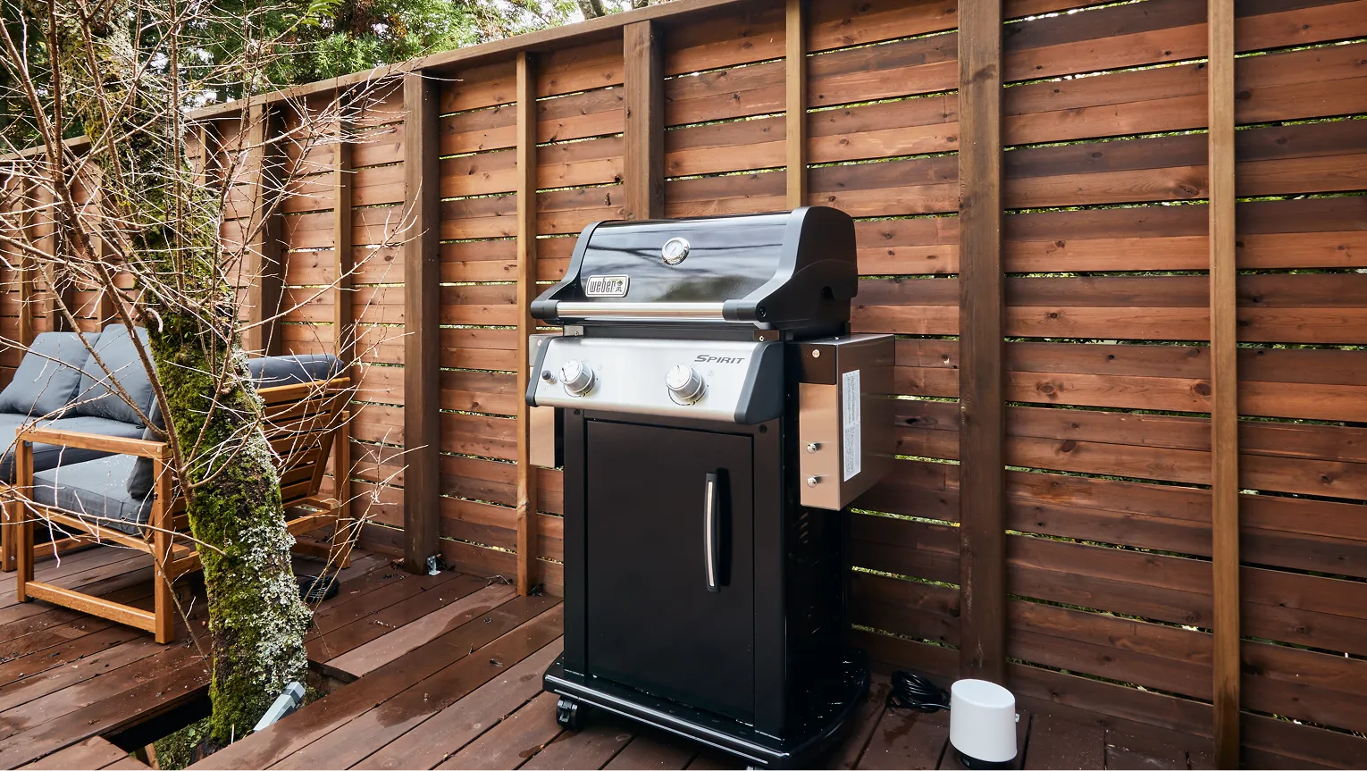 Gas-fired Weber BBQ grill on the wooden deck