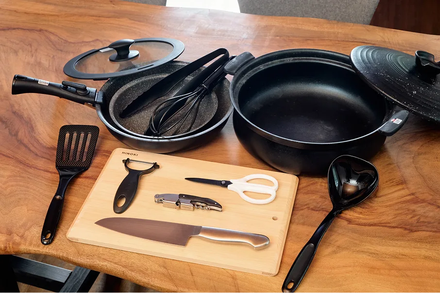 Pots, pans, knives, cutting board, and other cooking utensils