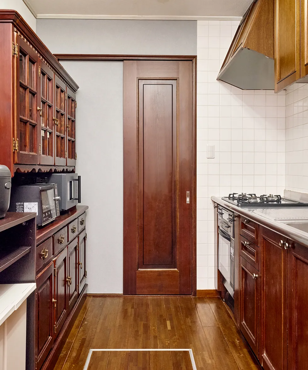Wooden cabinetry and generous counter space in the kitchen