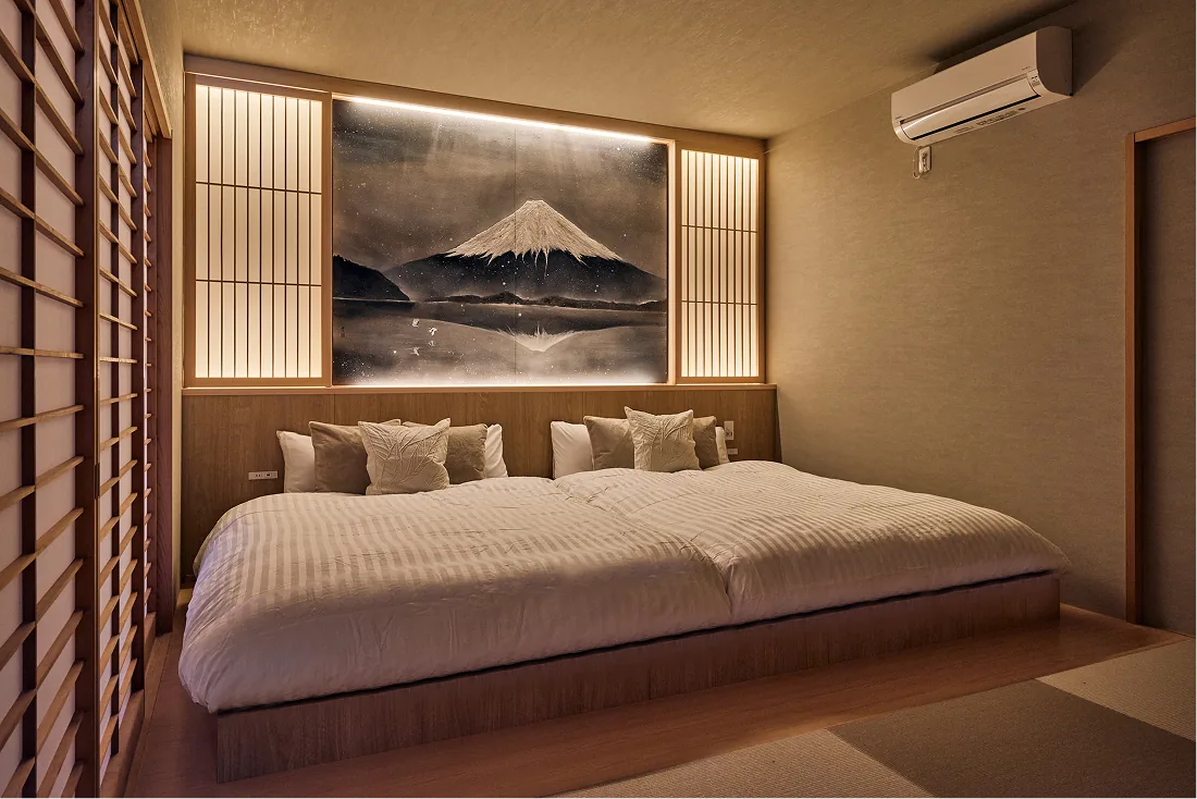 Japanese-modern bedroom with an ink painting of Mt. Fuji and two double beds