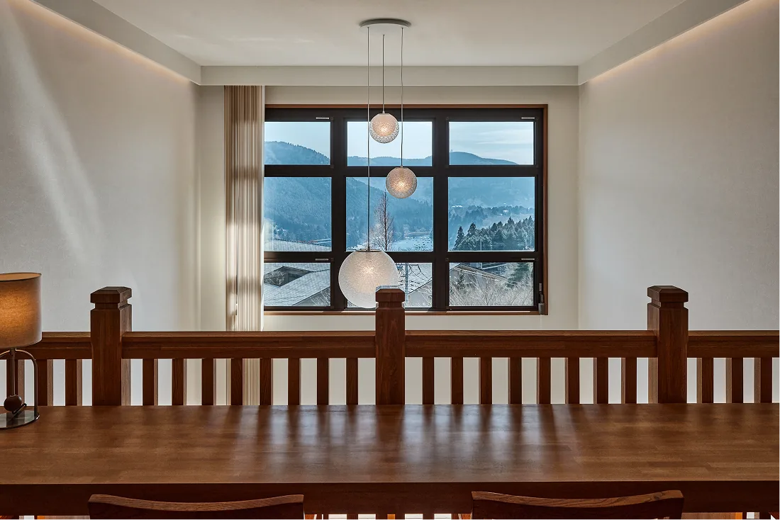 Long table by the large second-floor window with mountain views