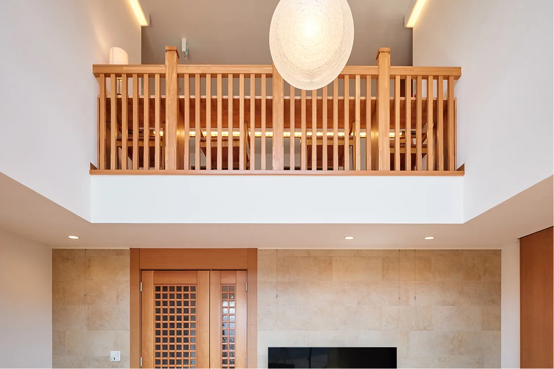 Second-floor gallery seating above the atrium with a large pendant light