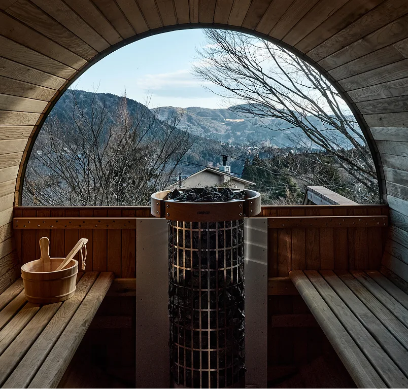 Inside the Nordic-style barrel sauna with a sauna bucket and ladle