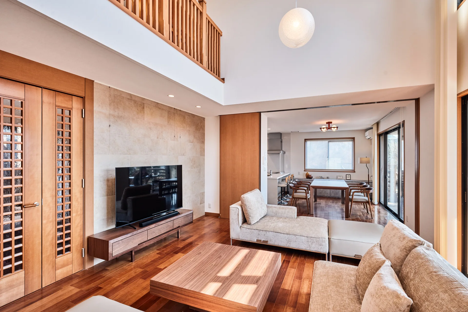 Bright living room with a loft under the vaulted ceiling