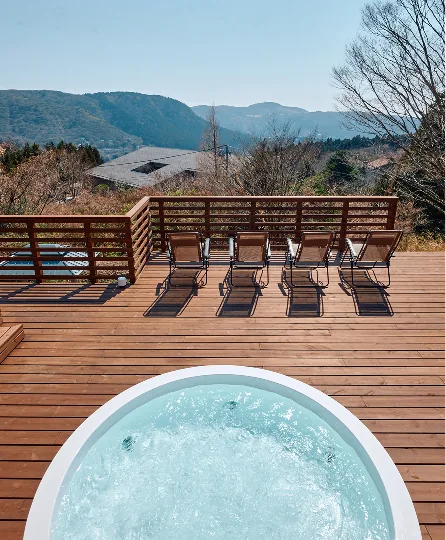 Large jacuzzi and loungers on the deck overlooking the Hakone mountains