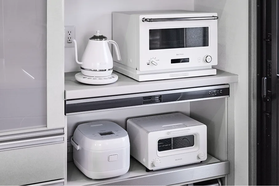Kitchen with BALMUDA microwave, toaster, electric kettle, and rice cooker