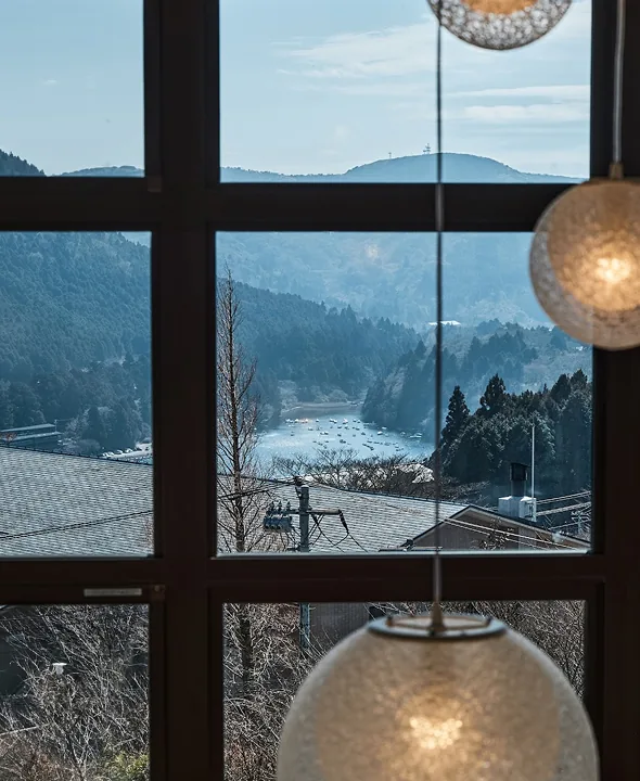 Lake Ashi and the mountains seen through the latticed window with pendant lights