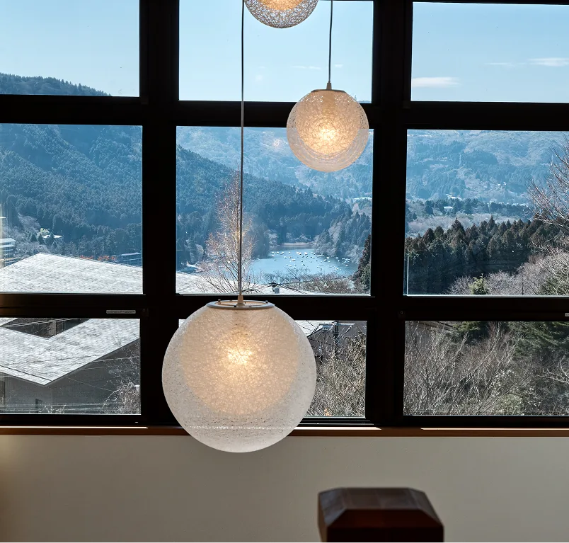 Lake Ashi seen through the latticed windows with spherical pendant lights