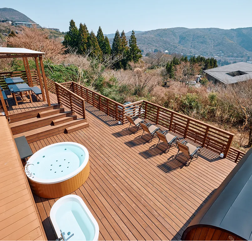 Bird's-eye view of the 200 m² wooden deck with jacuzzi, loungers, and pergola