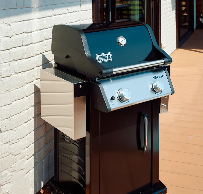 Gas-powered Weber BBQ grill on the wooden deck
